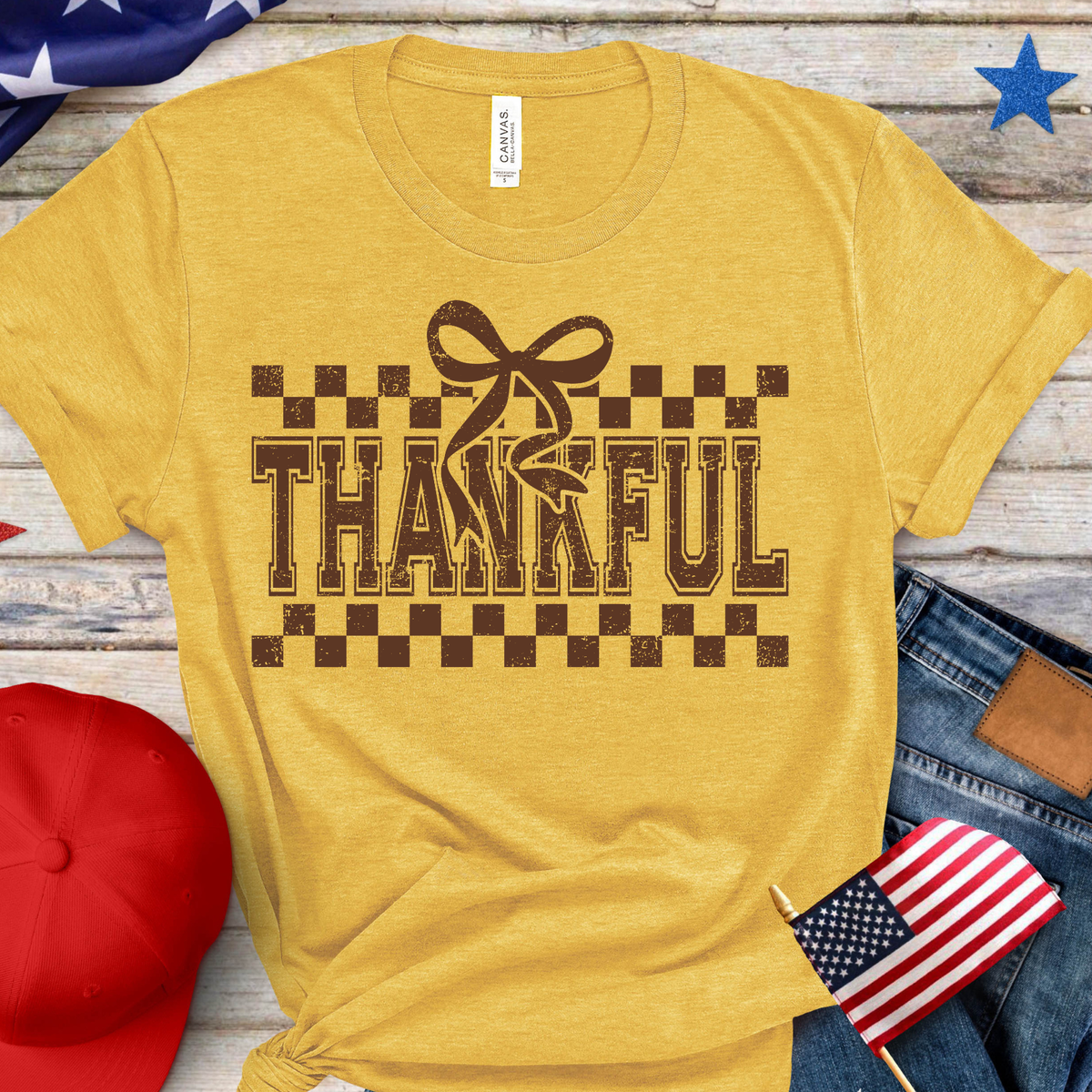 Brown checkered THANKFUL lettering decorated with a coordinating bow.