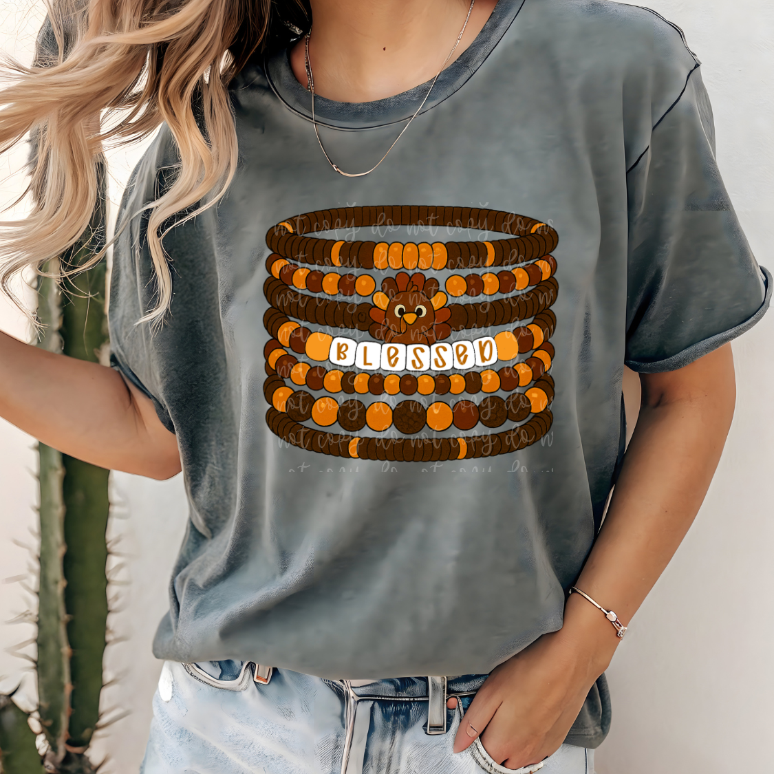 Two stacked Thanksgiving-inspired friendship bracelets in orange, black, and white beads.
