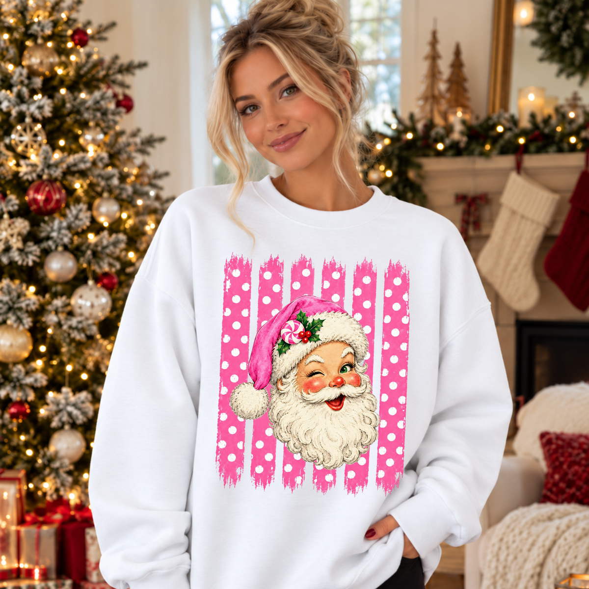 A woman wearing a white crewneck sweatshirt with a pink and white polka dot graphic of a retro Santa Claus face on the front.