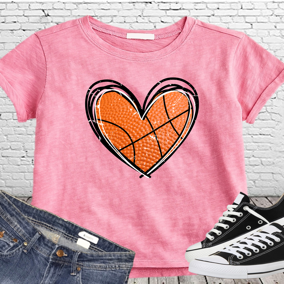 Pink shirt featuring a large orange basketball-shaped heart outlined in black.