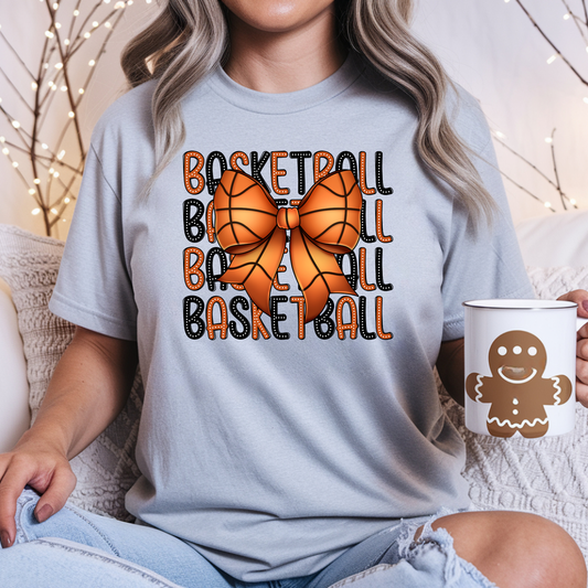 Gray shirt featuring repeated basketball and baseball lettering in orange and black with a small basketball graphic.