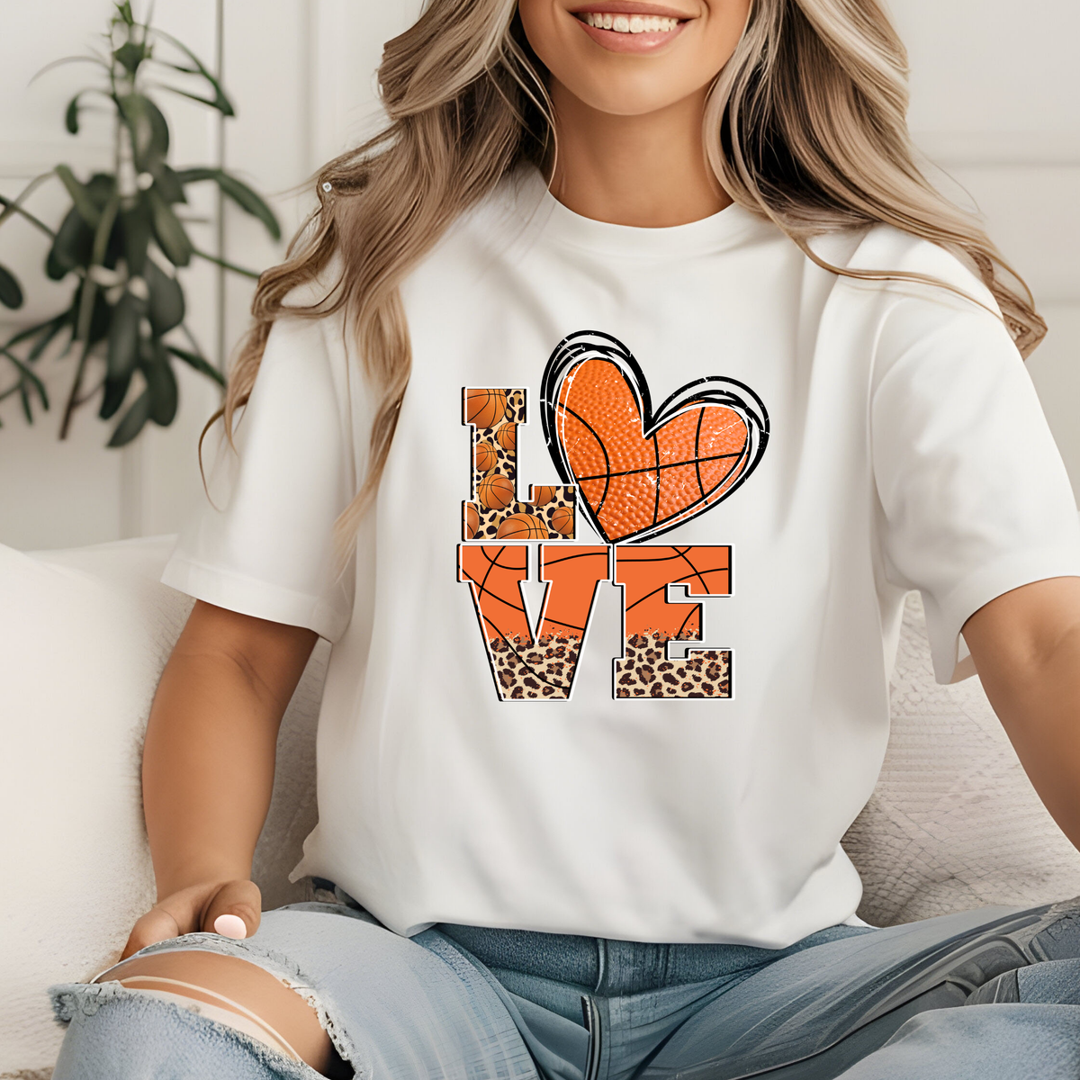 White shirt featuring LOVE lettering with orange basketball graphics and a decorative bow.