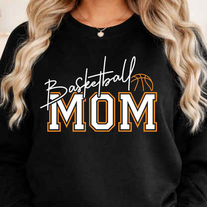 Black shirt featuring Basketball Mom lettering in white and orange with a basketball illustration.