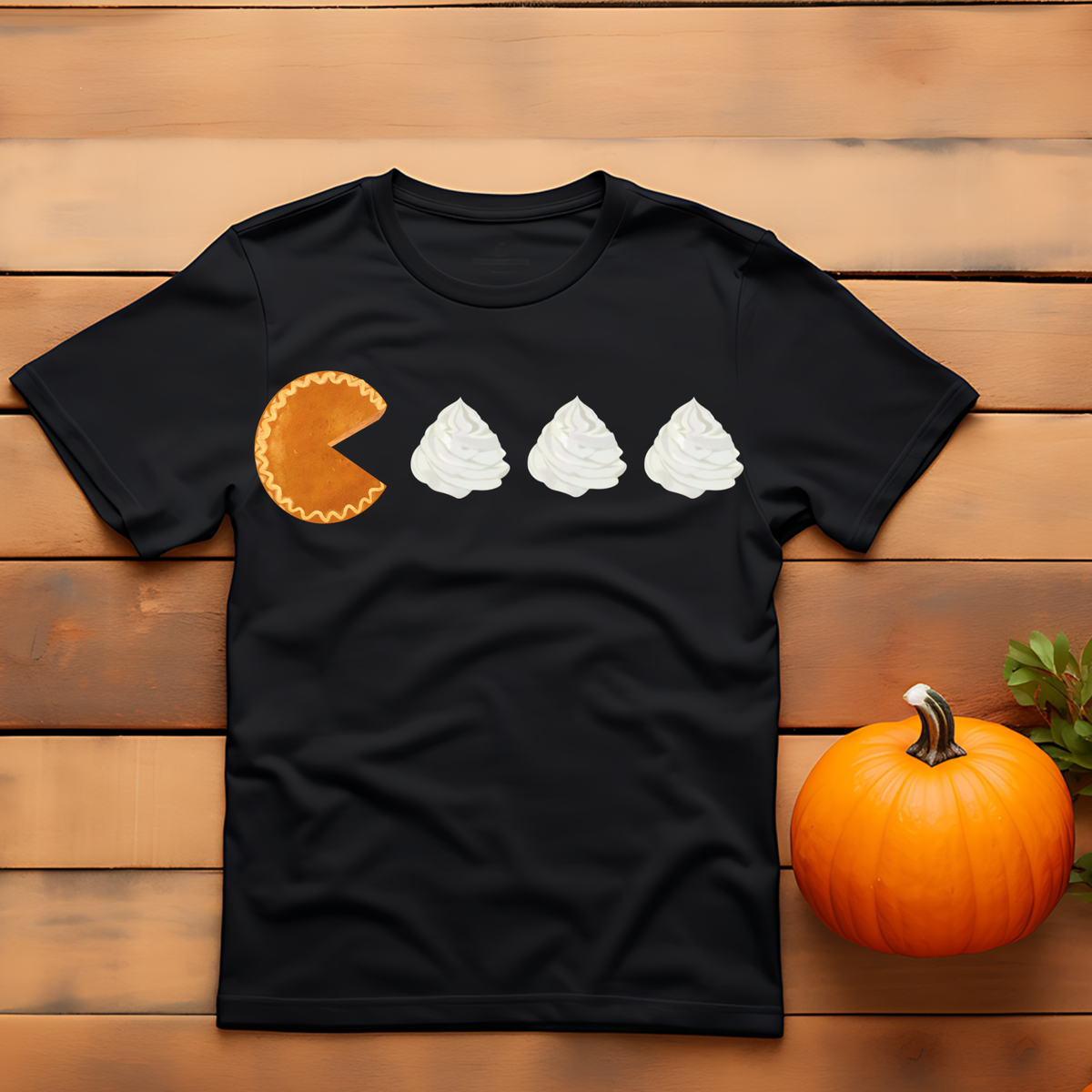 Pumpkin pie slice and three dollops of whipped cream arranged in a simple fall-themed design.
