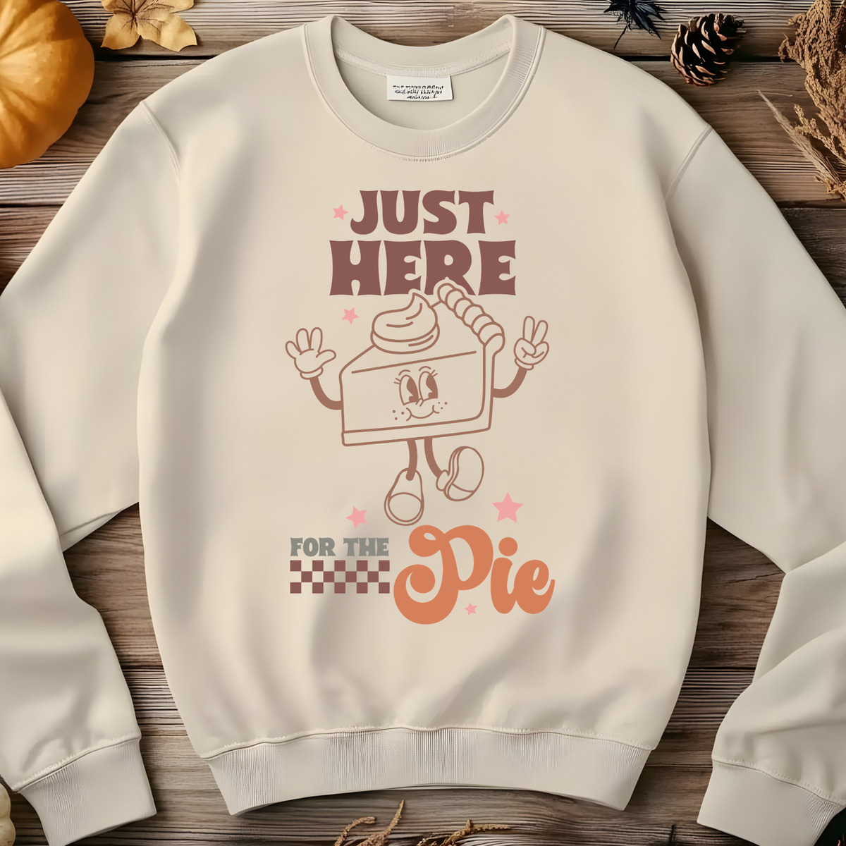 Cute smiling slice of pumpkin pie with raised arms and Just Here for the Pie lettering.