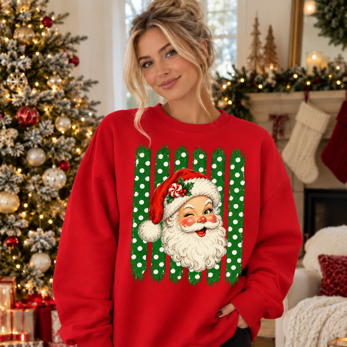 A woman wearing a red crewneck sweatshirt with a festive Christmas graphic of Santa Claus's face in front of green and white polka-dot vertical stripes.